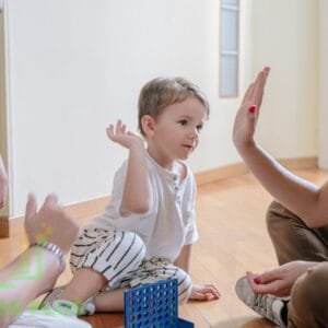 Happy parents bonding with their child while learning advanced parenting skills.